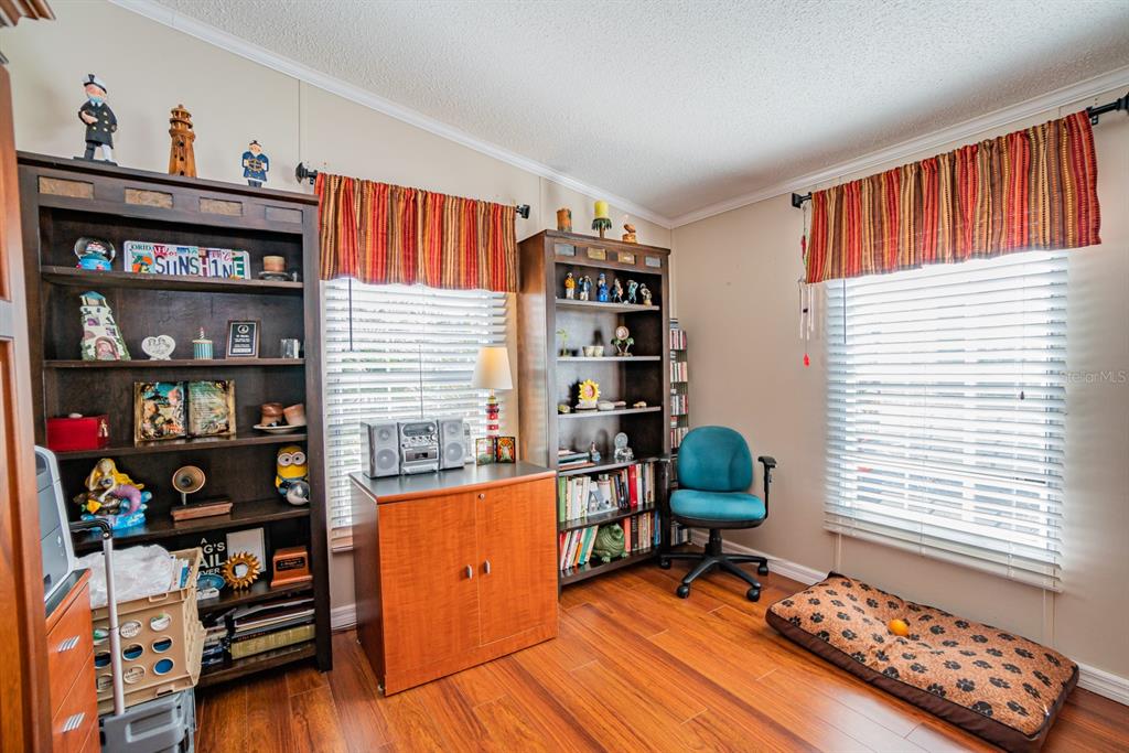 10303 Burnt Store Road, Unit 203 Punta Gorda, FL 33950 - Photo 17 of 41 a workspace with furniture and book shelf