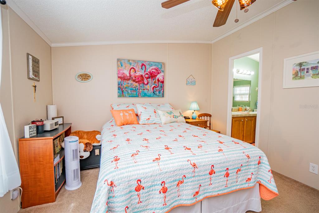 10303 Burnt Store Road, Unit 203 Punta Gorda, FL 33950 - Photo 20 of 41 a bedroom with a bed and wooden floor