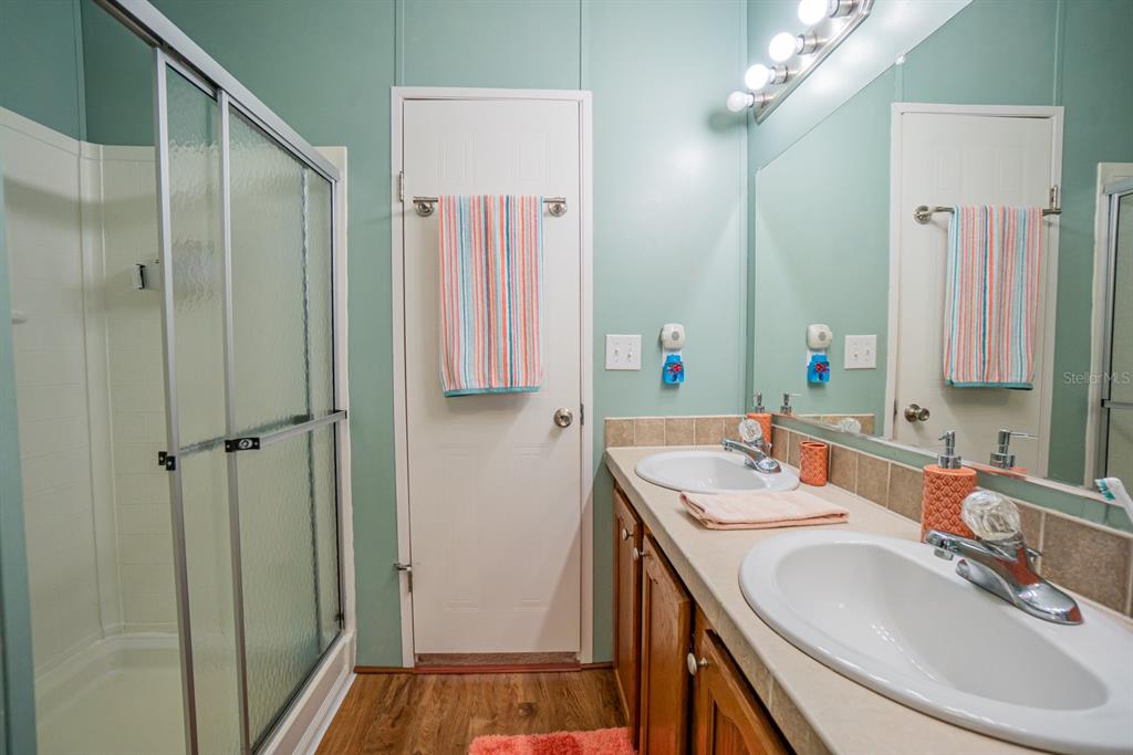 10303 Burnt Store Road, Unit 203 Punta Gorda, FL 33950 - Photo 21 of 41 a bathroom with a sink double vanity and a mirror