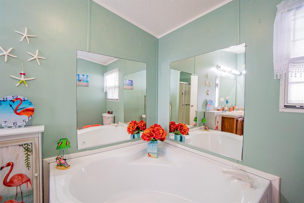 10303 Burnt Store Road, Unit 203 Punta Gorda, FL 33950 - Photo 23 of 41 a white bath tub sitting next to a bathroom