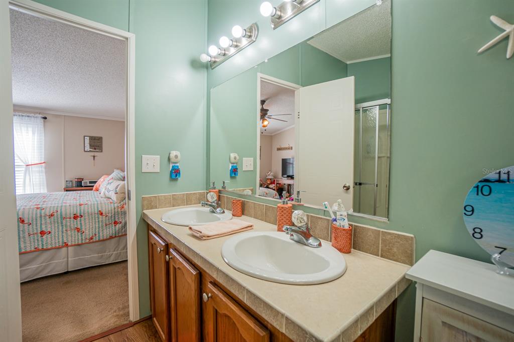 10303 Burnt Store Road, Unit 203 Punta Gorda, FL 33950 - Photo 24 of 41 a bathroom with a sink double vanity and a mirror