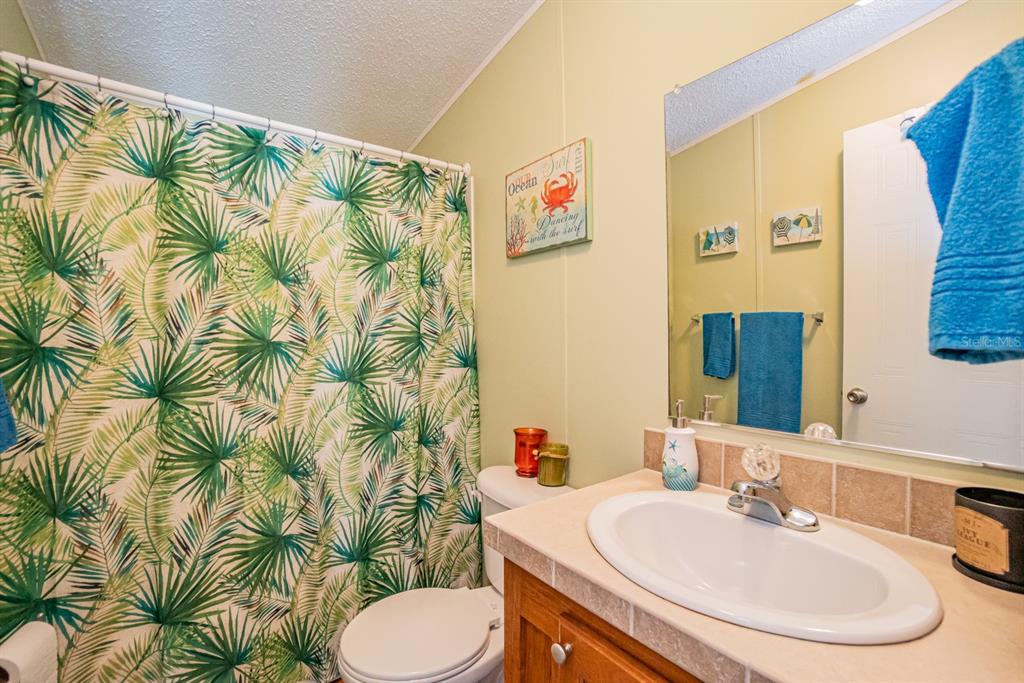 10303 Burnt Store Road, Unit 203 Punta Gorda, FL 33950 - Photo 26 of 41 a bathroom with a sink and a mirror