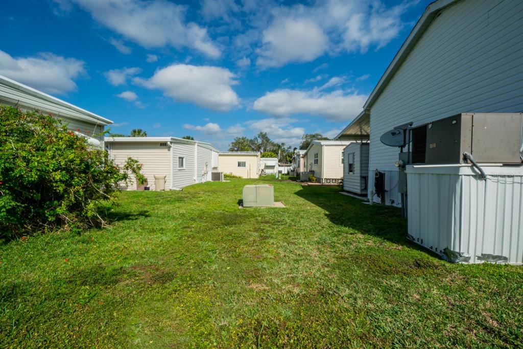10303 Burnt Store Road, Unit 203 Punta Gorda, FL 33950 - Photo 36 of 41 a view of a back yard of the house