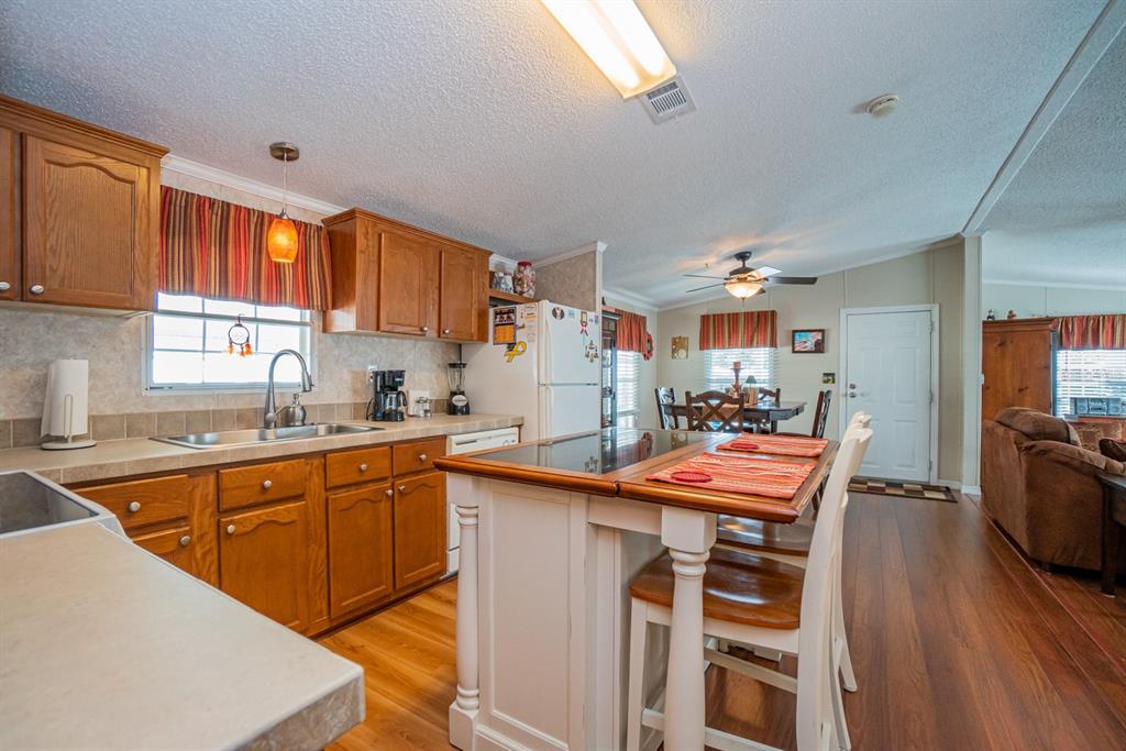 10303 Burnt Store Road, Unit 203 Punta Gorda, FL 33950 - Photo 8 of 41 a kitchen with stainless steel appliances granite countertop a sink and a refrigerator
