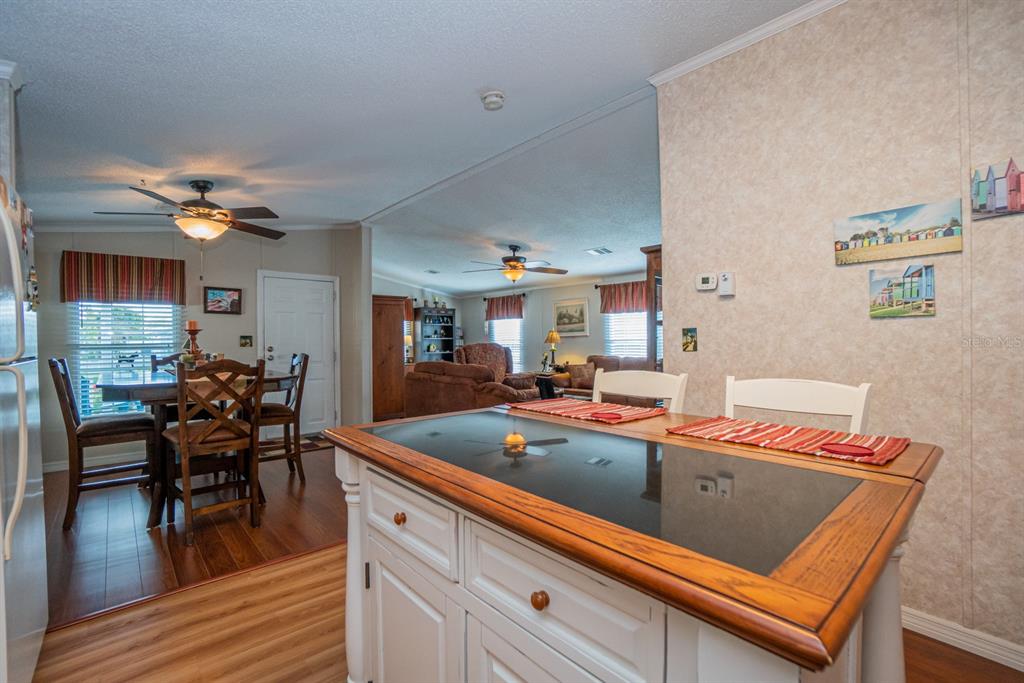 10303 Burnt Store Road, Unit 203 Punta Gorda, FL 33950 - Photo 9 of 41 a view of a dining room with furniture and wooden floor