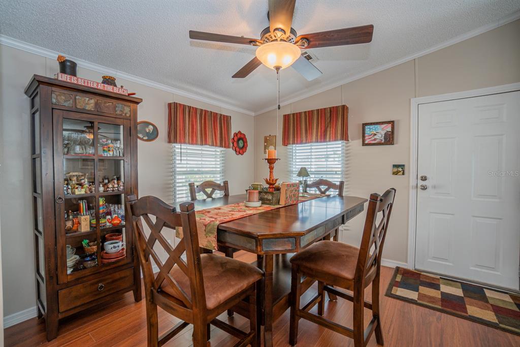 10303 Burnt Store Road, Unit 203 Punta Gorda, FL 33950 - Photo 10 of 41 a view of a dining room with furniture and a chandelier
