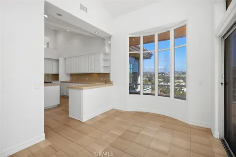 a view of an empty room with a fireplace and a window