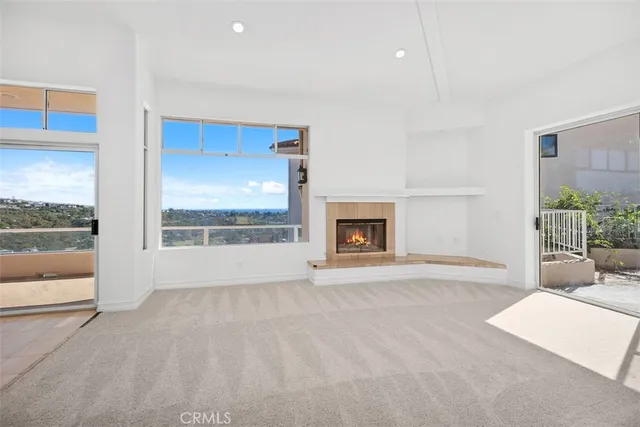 a view of a livingroom with an empty space and a fireplace