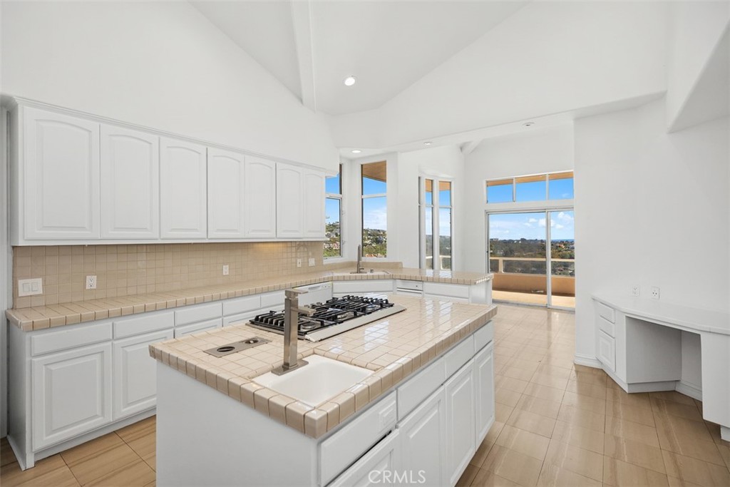 4 Tesoro San Clemente, CA 92673 - Photo 22 of 60 a kitchen that has a sink a stove and wooden floor