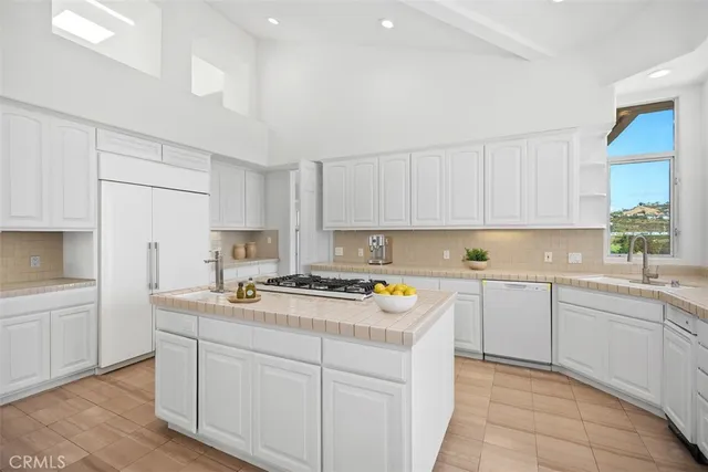 a kitchen with a sink and a large window