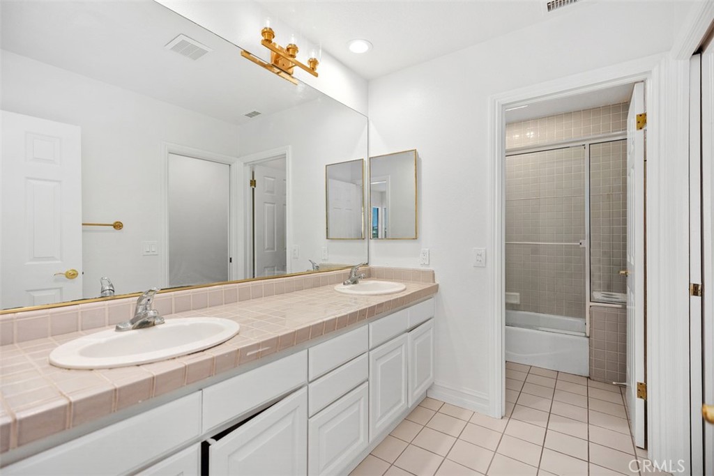 4 Tesoro San Clemente, CA 92673 - Photo 39 of 60 a bathroom with a sink double vanity granite tub and a mirror