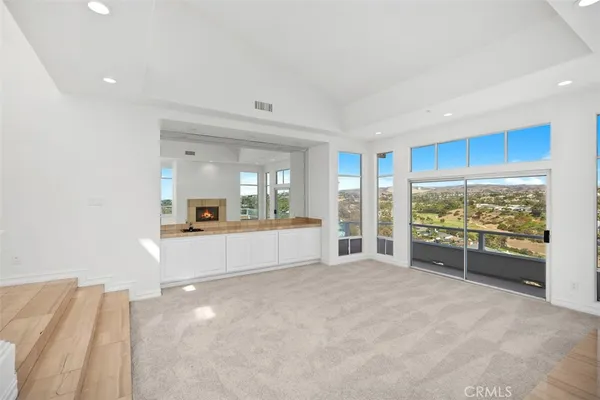 a view of a livingroom with an empty space and a fireplace