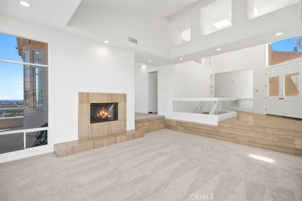4 Tesoro San Clemente, CA 92673 - Photo 9 of 60 a view of an empty room with a fireplace and a window