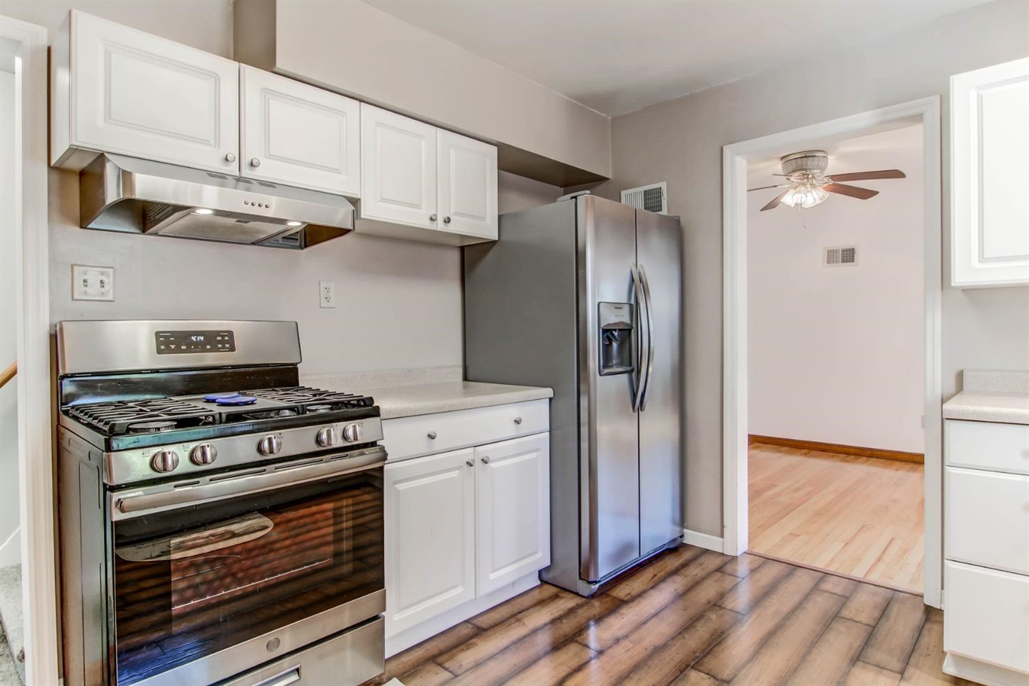 3115 Ridge Road Highland, IN 46322 - Photo 16 of 33 a kitchen with stainless steel appliances white cabinets and a stove top oven