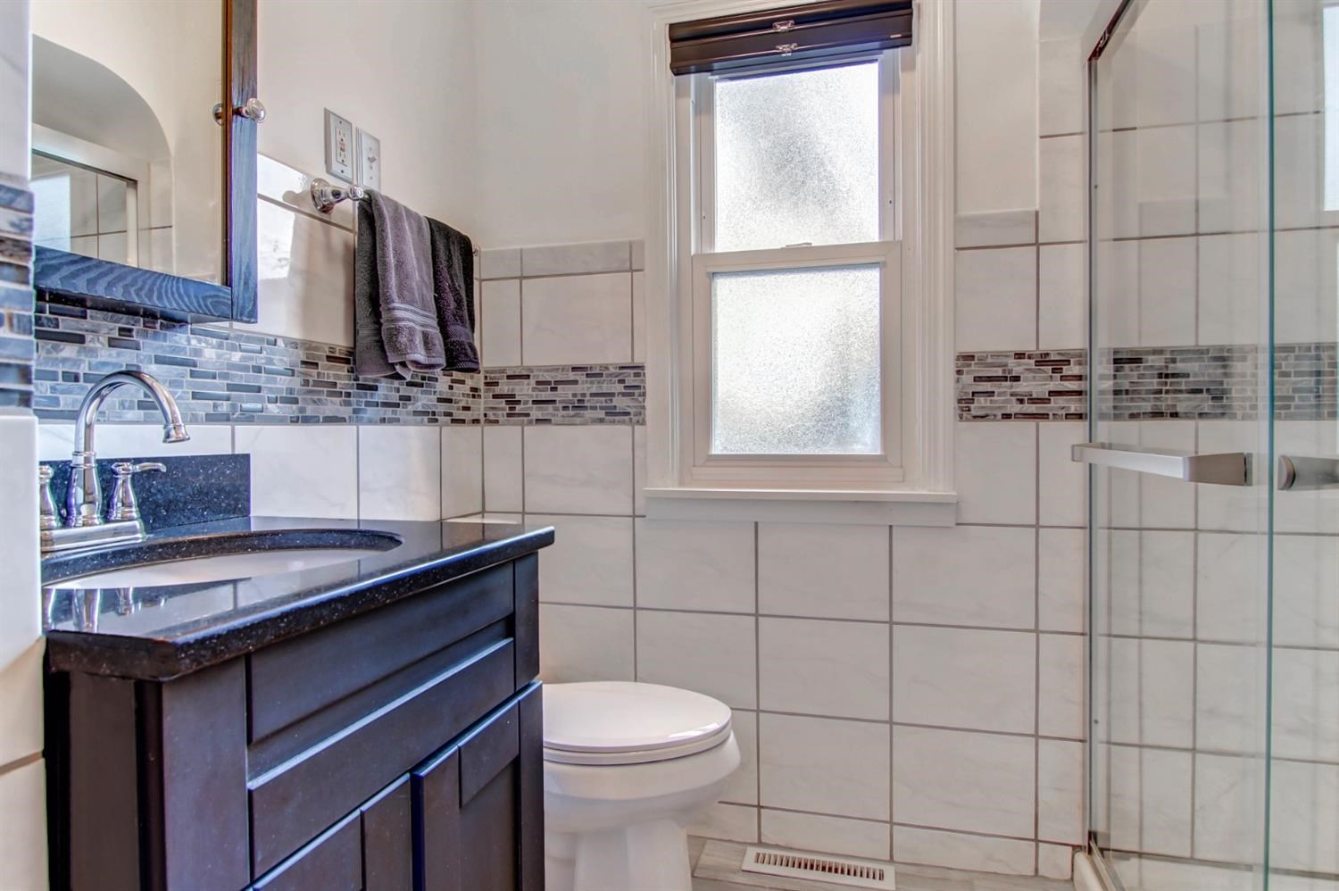 3115 Ridge Road Highland, IN 46322 - Photo 21 of 33 a bathroom with a sink a toilet and mirror