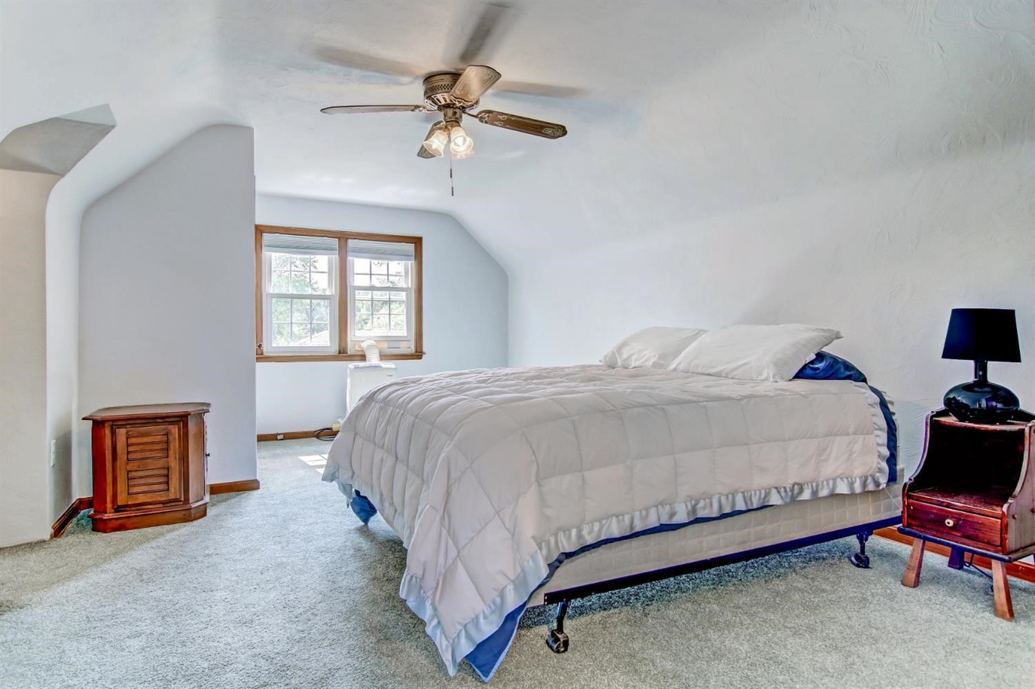 3115 Ridge Road Highland, IN 46322 - Photo 25 of 33 a spacious bedroom with a bed and a chandelier