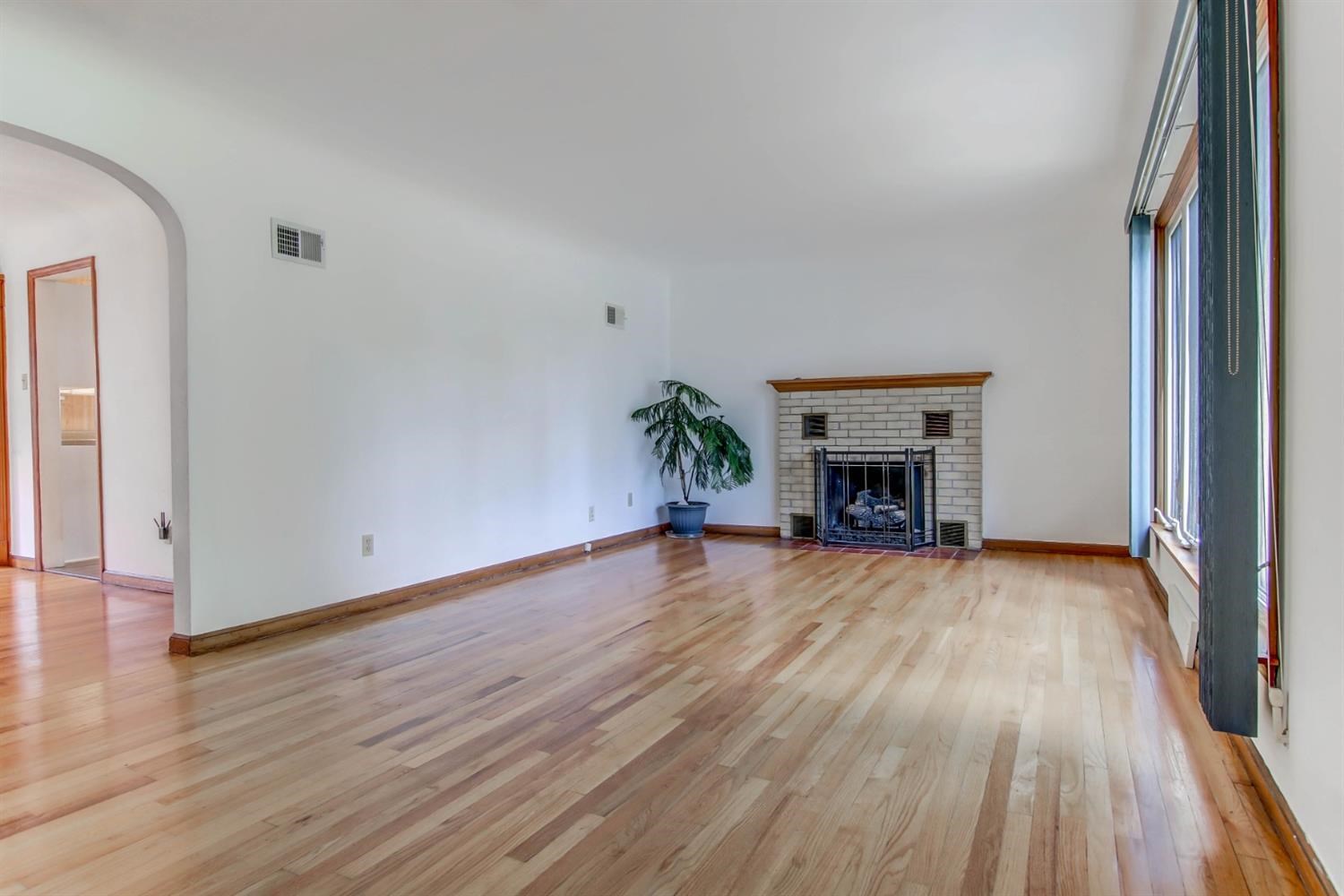 3115 Ridge Road Highland, IN 46322 - Photo 5 of 33 a view of empty room with wooden floor and fireplace