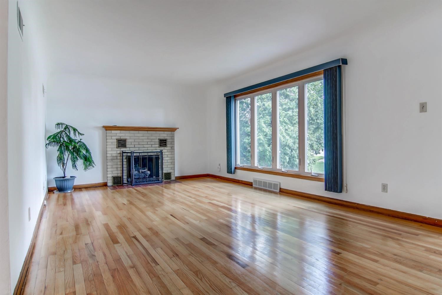 3115 Ridge Road Highland, IN 46322 - Photo 6 of 33 a view of an empty room with wooden floor and a window