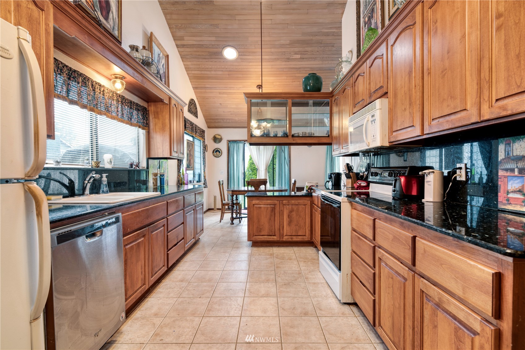 17315 Clover Road Bothell, WA 98012 - Photo 7 of 24 a large kitchen with stainless steel appliances granite countertop a stove a sink and dishwasher