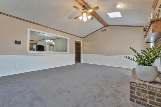 a view of a big room with windows and flower pot