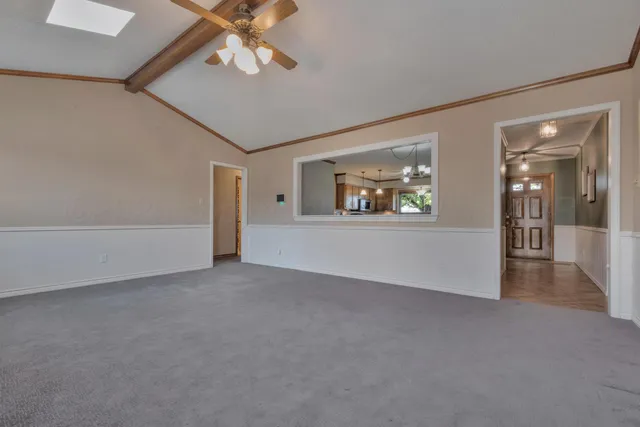 an empty room with fan and windows