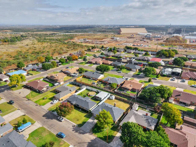 an aerial view of residential houses with outdoor space