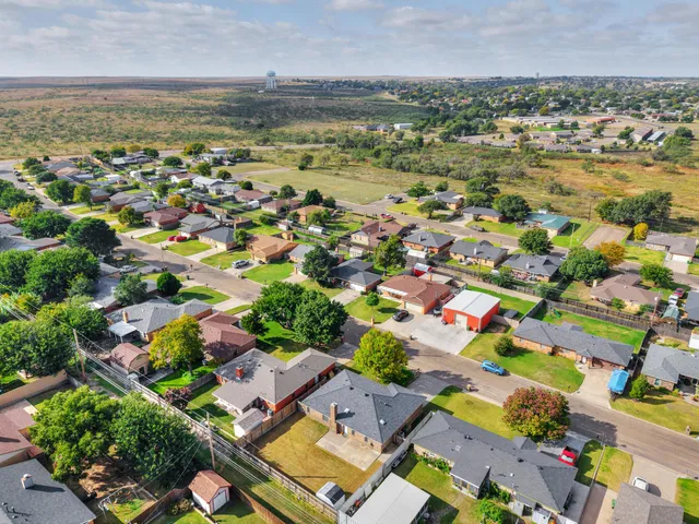 an aerial view of residential houses with outdoor space