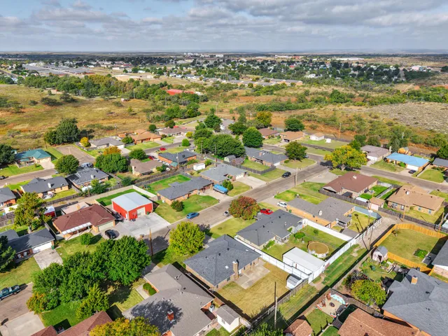 an aerial view of residential building and lake