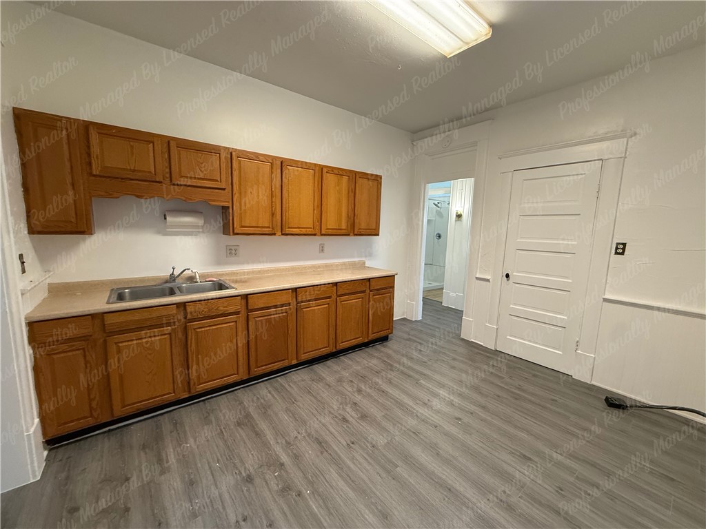 44 West High Street, Unit B Springfield, OH 45502 - Photo 23 of 31 This kitchen features classic cabinetry and durable flooring, offering a practical space for everyday living.
