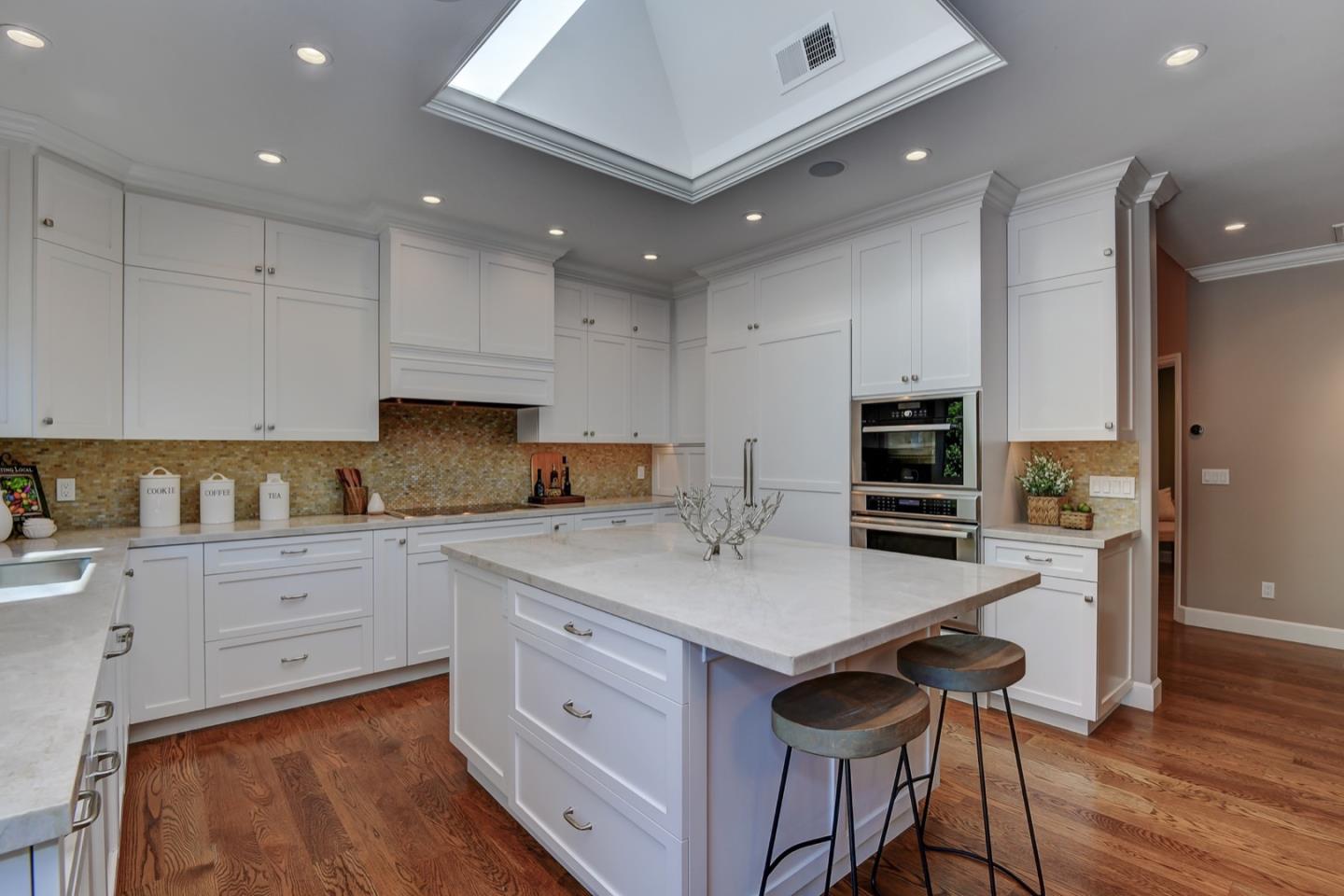 650 Chesley Avenue Mountain View, CA 94040 - Photo 11 of 32 a kitchen with white cabinets stainless steel appliances and wooden floor