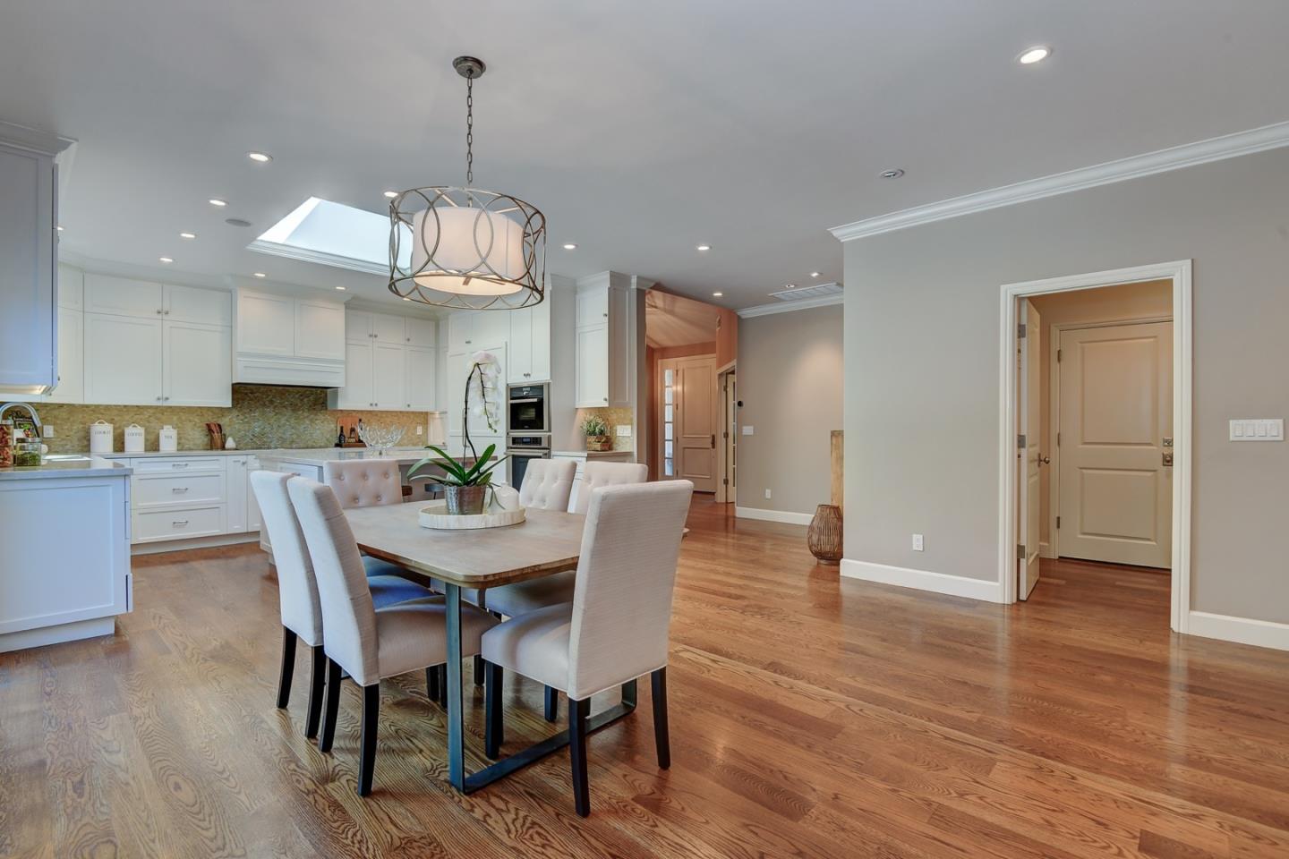 650 Chesley Avenue Mountain View, CA 94040 - Photo 8 of 32 a view of a dining room and livingroom with furniture wooden floor a chandelier