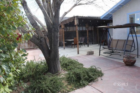 1624 South Farragut Street Ridgecrest, CA 93555 - Photo 35 of 43 a view of backyard with wheel and chair