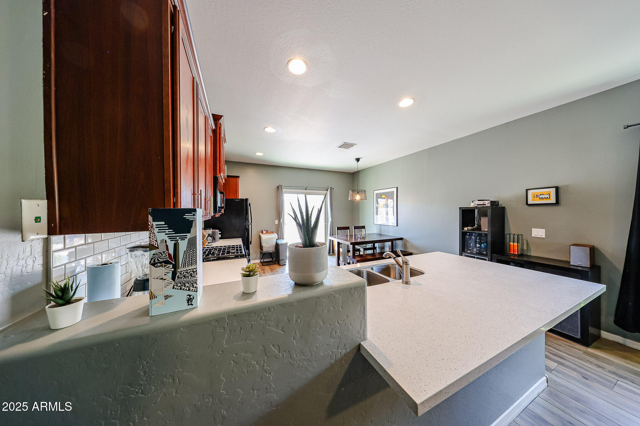7525 West Carter Road Laveen, AZ 85339 - Photo 8 of 24 a dining room with kitchen island a table and chairs in it