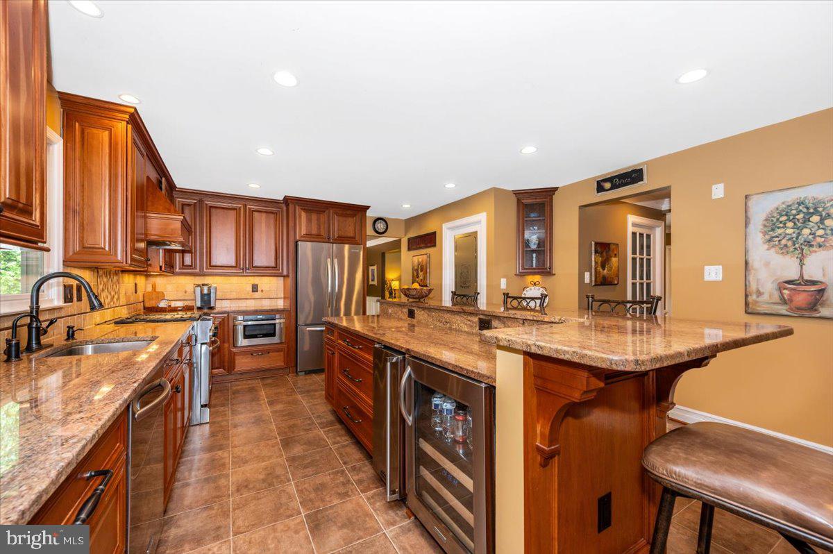 8412 Dasher Court Gaithersburg, MD 20882 - Photo 12 of 83 a kitchen with stainless steel appliances granite countertop a sink stove and refrigerator