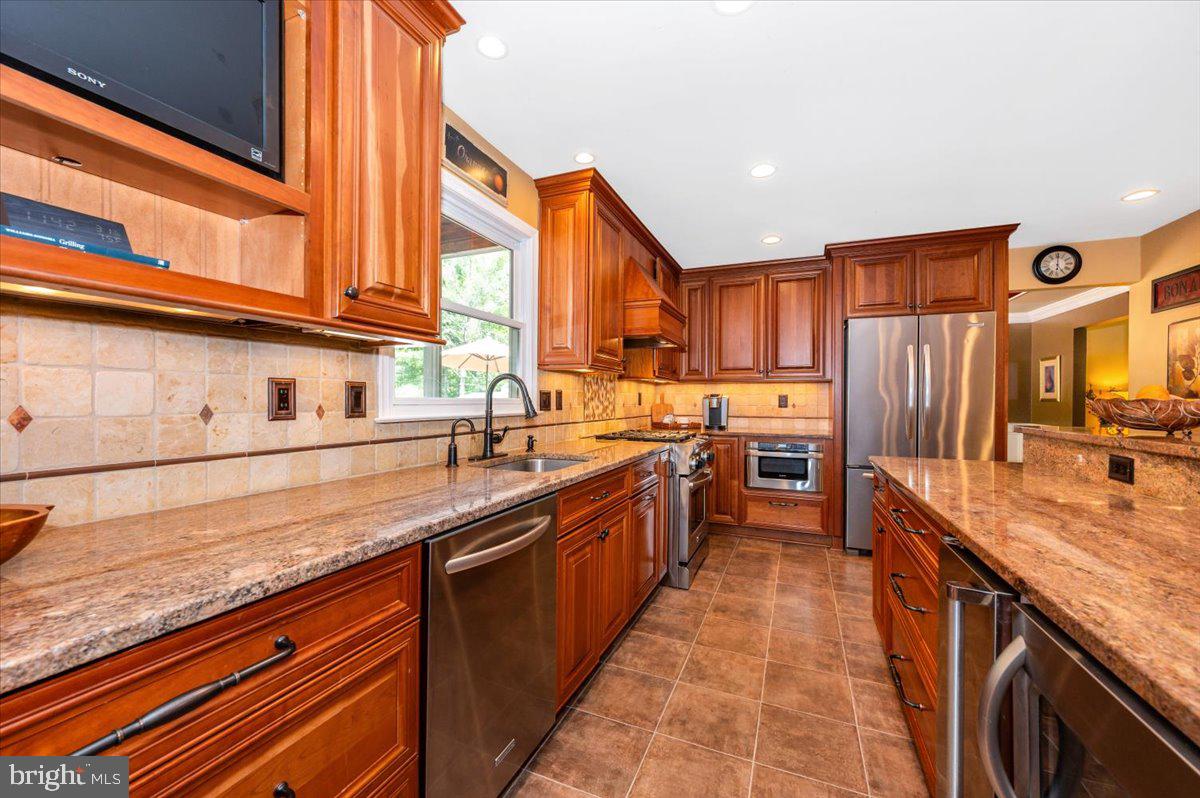 8412 Dasher Court Gaithersburg, MD 20882 - Photo 13 of 83 a large kitchen with stainless steel appliances granite countertop a stove a sink and a refrigerator