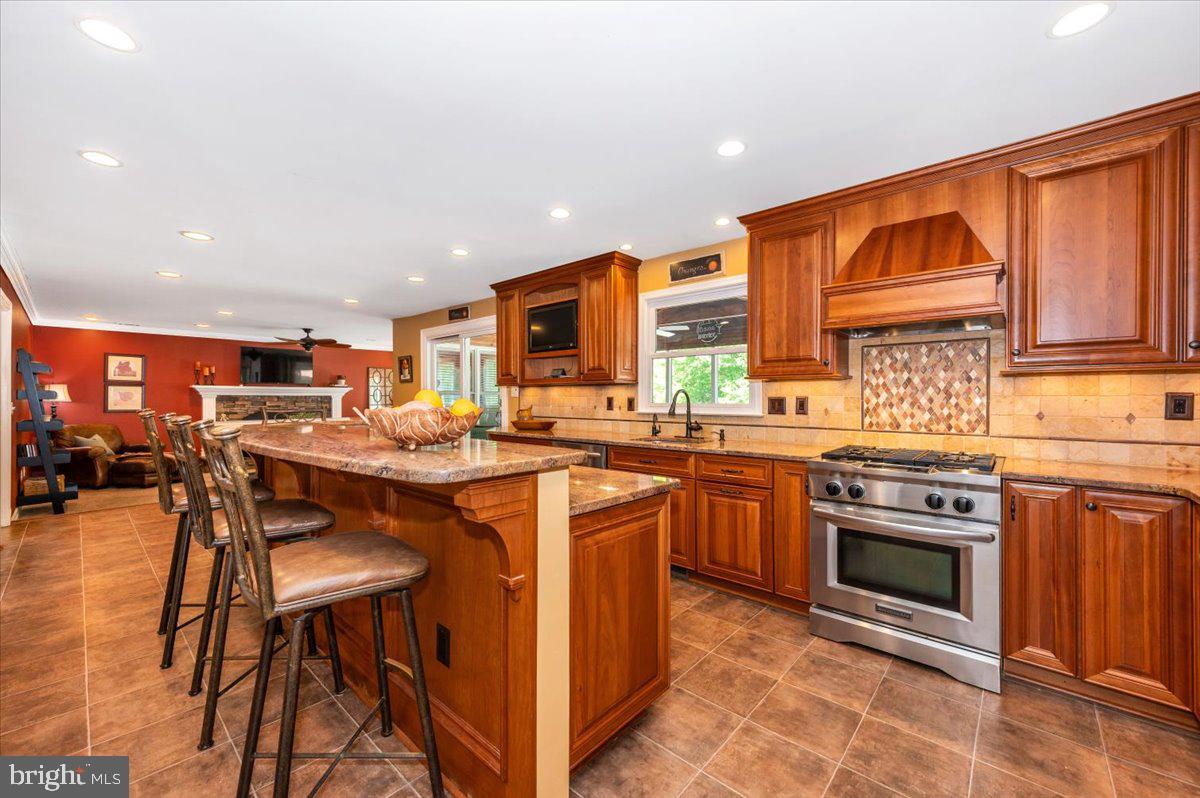 8412 Dasher Court Gaithersburg, MD 20882 - Photo 15 of 83 a kitchen with stainless steel appliances granite countertop a stove top oven a sink and a refrigerator