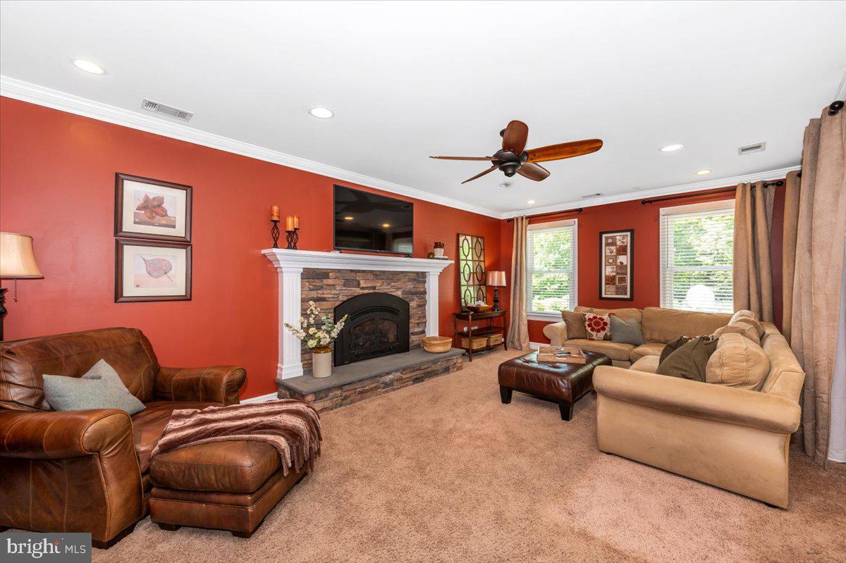 8412 Dasher Court Gaithersburg, MD 20882 - Photo 18 of 83 a living room with furniture a fireplace and a chandelier