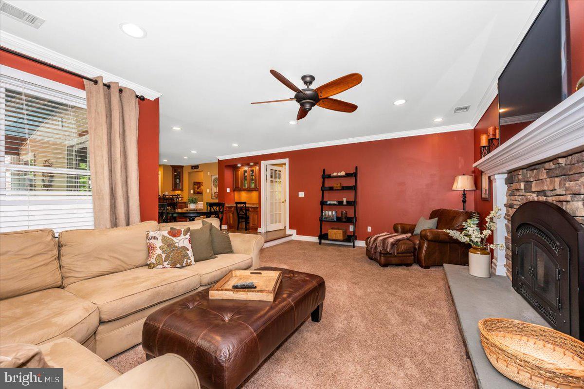 8412 Dasher Court Gaithersburg, MD 20882 - Photo 20 of 83 a living room with furniture a fireplace and a large window