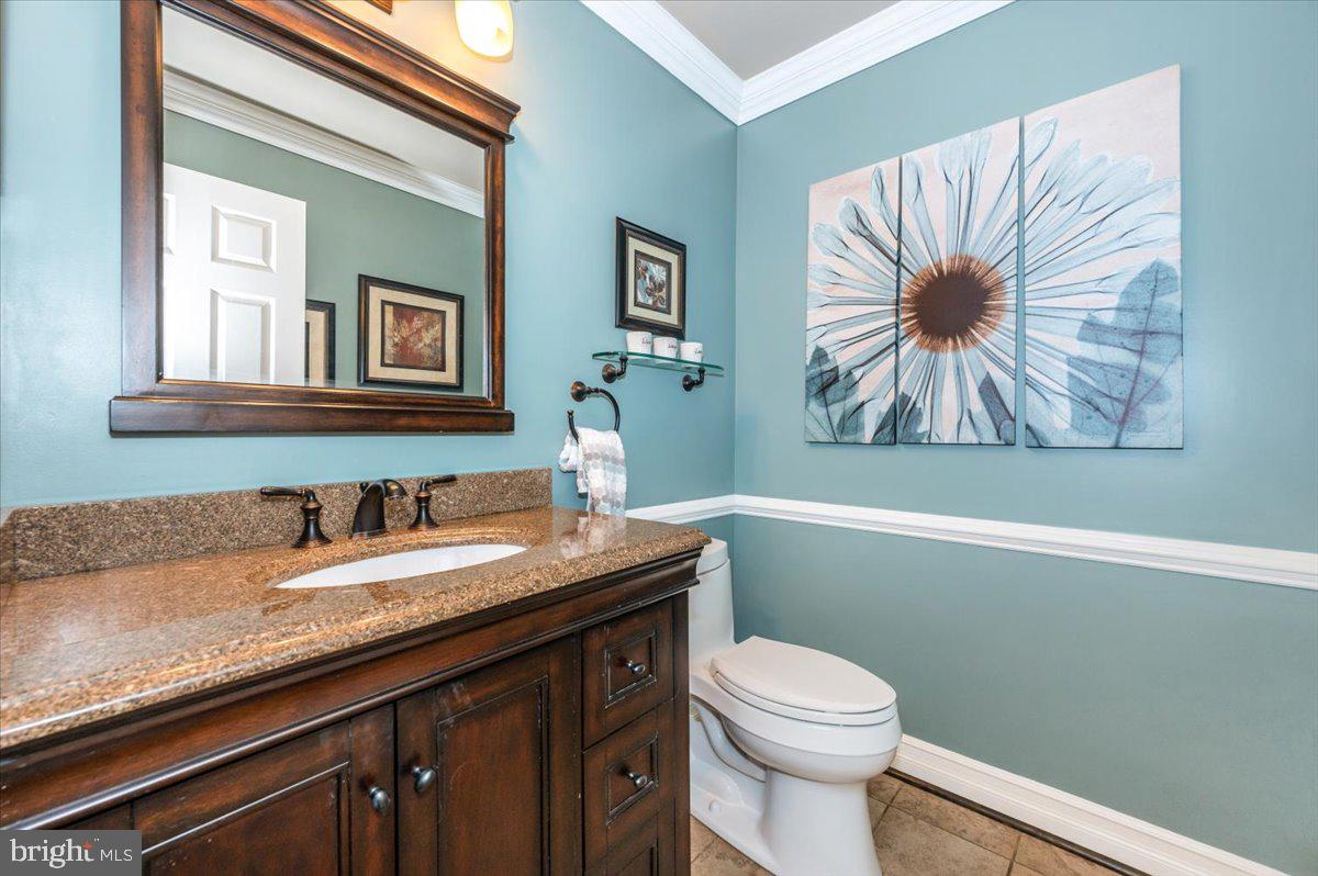 8412 Dasher Court Gaithersburg, MD 20882 - Photo 23 of 83 a bathroom with a granite countertop sink a toilet and a mirror