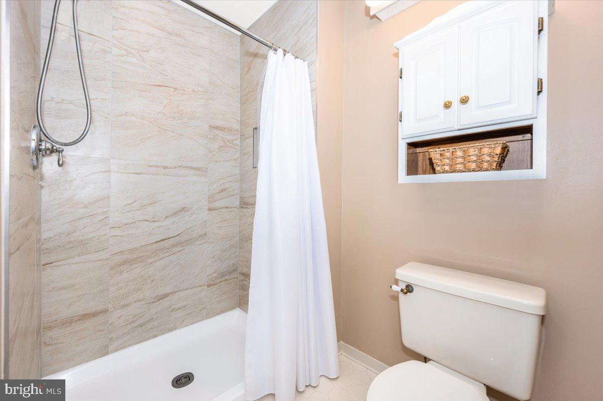 8412 Dasher Court Gaithersburg, MD 20882 - Photo 33 of 83 a bathroom with a toilet and a shower