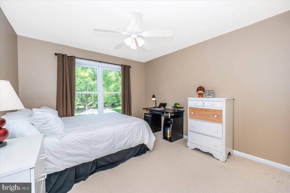 8412 Dasher Court Gaithersburg, MD 20882 - Photo 34 of 83 a bedroom with a bed and a dresser