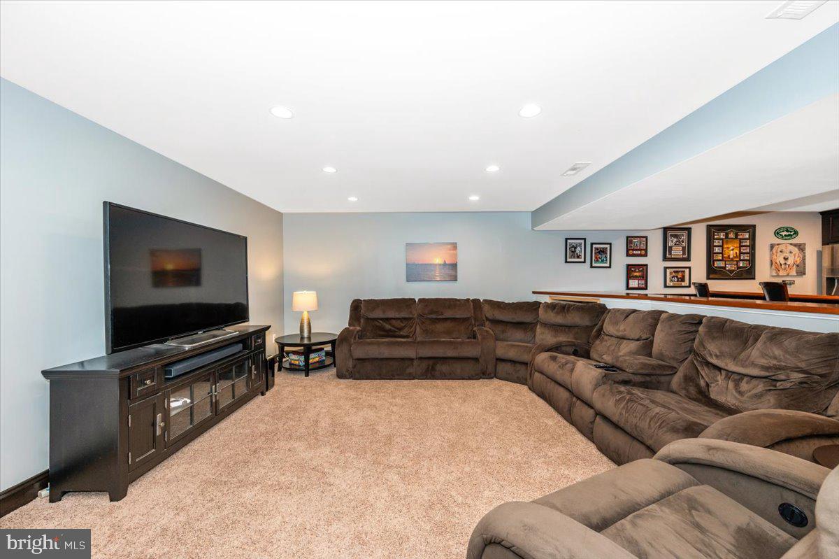 8412 Dasher Court Gaithersburg, MD 20882 - Photo 38 of 83 a living room with furniture and a flat screen tv