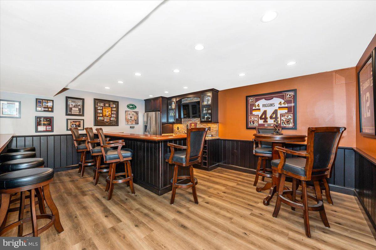 8412 Dasher Court Gaithersburg, MD 20882 - Photo 40 of 83 a view of a dining room with furniture and wooden floor