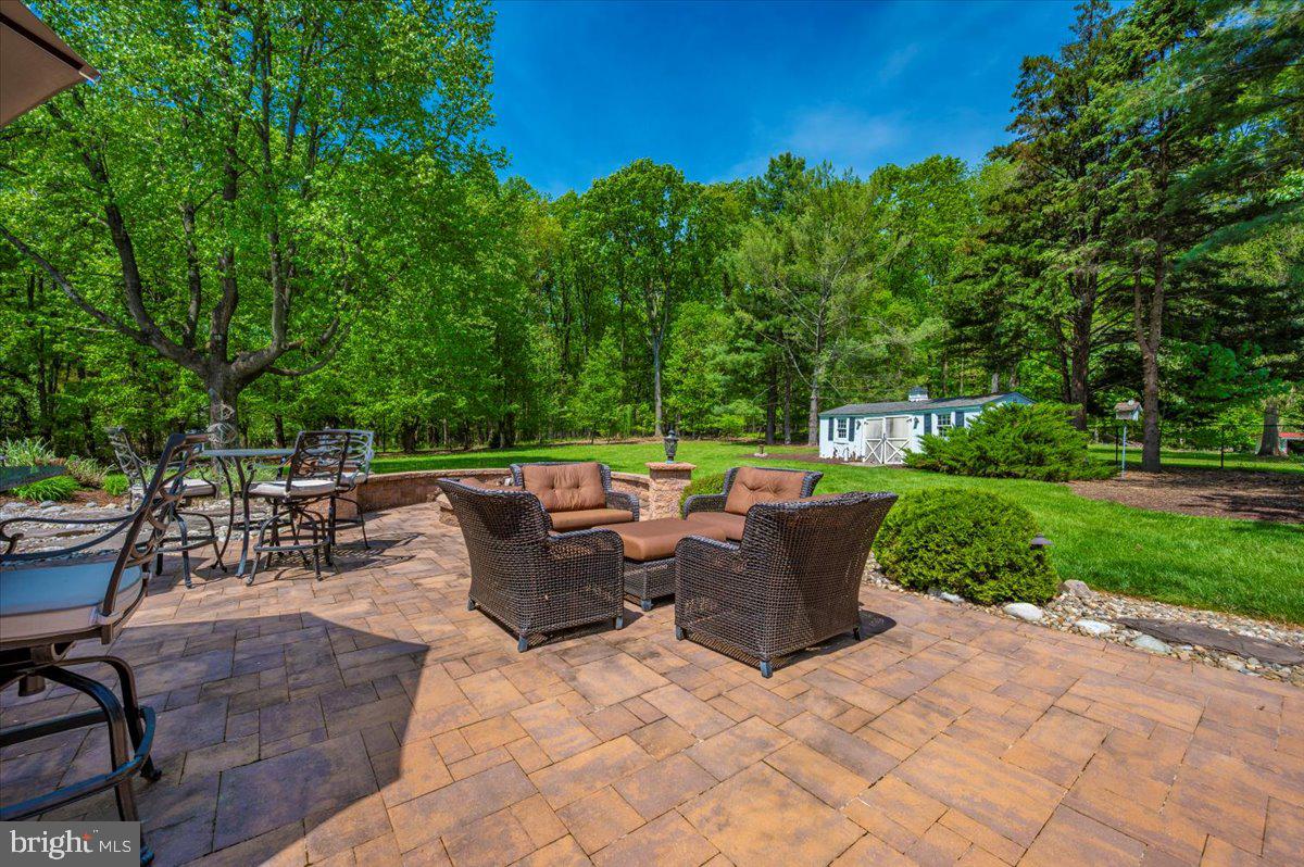 8412 Dasher Court Gaithersburg, MD 20882 - Photo 66 of 83 a view of a patio with table and chairs potted plants and large tree