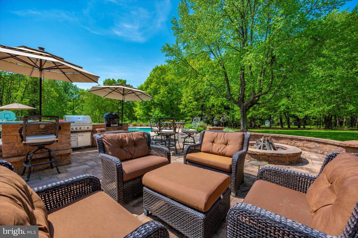 8412 Dasher Court Gaithersburg, MD 20882 - Photo 67 of 83 a view of patio with couches and a table and chairs under an umbrella