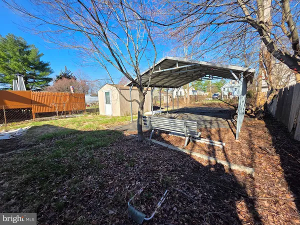 a view of a backyard with table and chairs under an umbrella