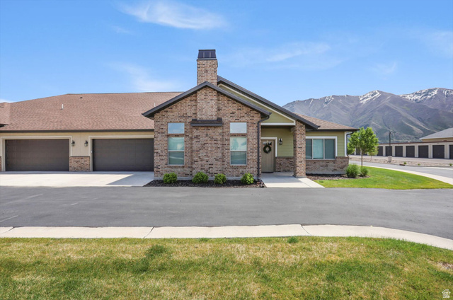 1838 West 300th Street South, Unit B Mapleton, UT 84664 - Photo 33 of 51 Brick exterior with green siding accents, featuring a prominent chimney and multiple windows