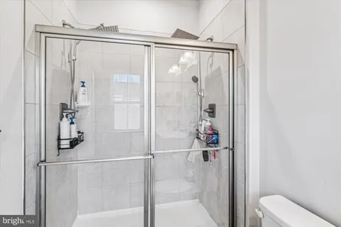 a bathroom with a shower and a sink