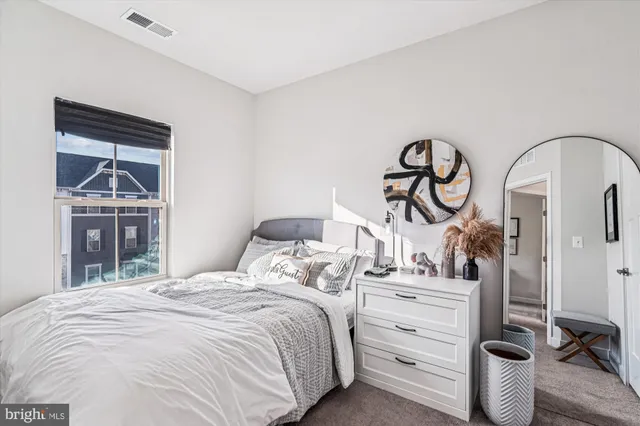 a bedroom with a bed and a closet with mirror