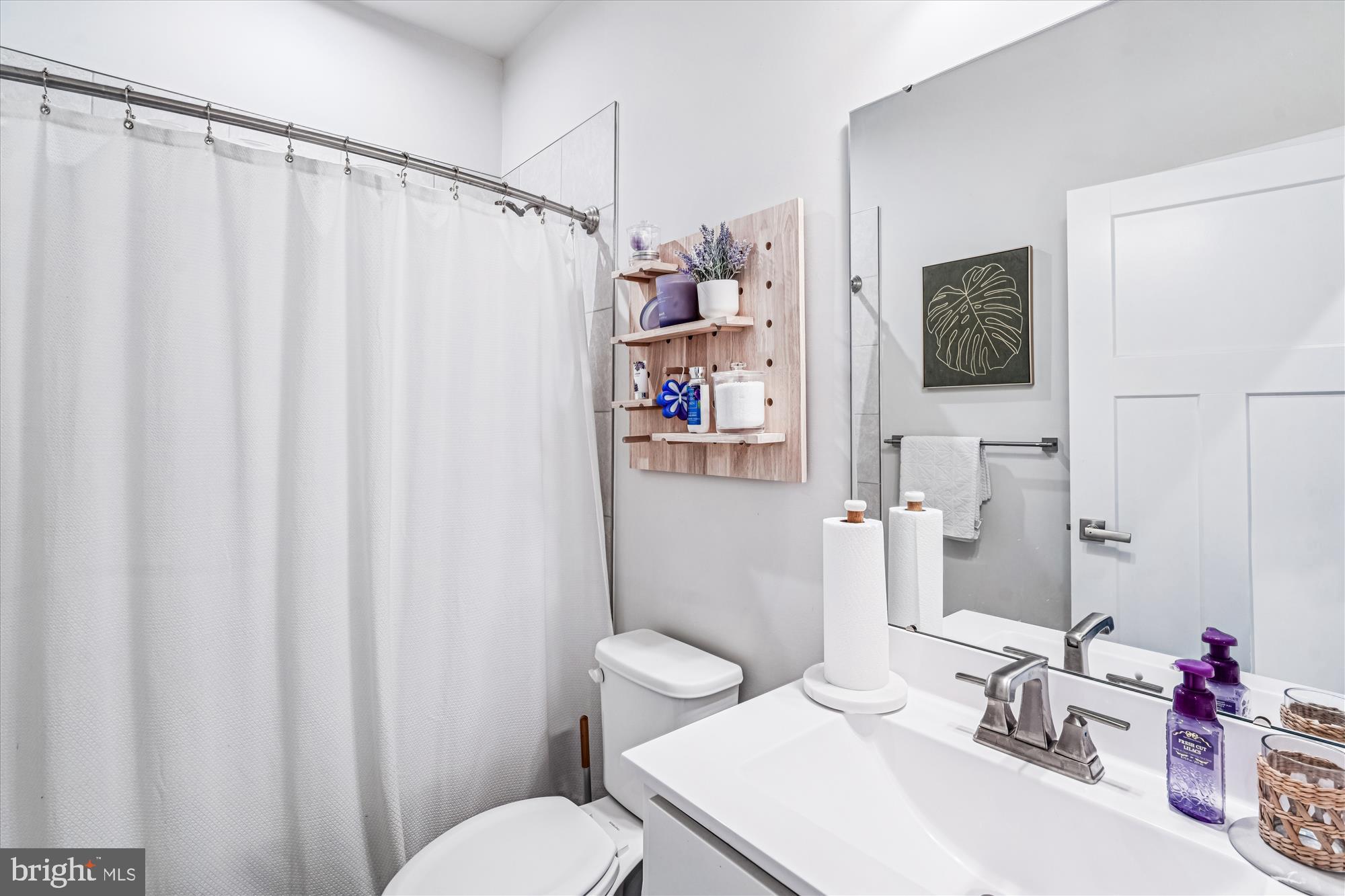 136 Brown Branch Road Laurel, MD 20708 - Photo 20 of 44 a bathroom with a sink a toilet and shower curtain